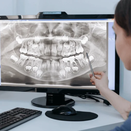 imagem de um dentista analisando um raio-x do paciente